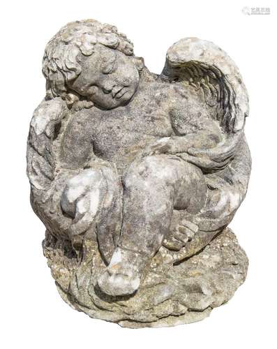 A stone figure of a recumbent cherub: sleeping in a woven basket, 40cm. long.