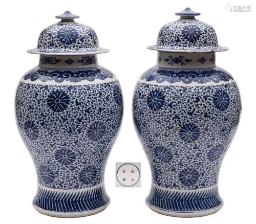 A pair of Chinese blue and white 'peony scroll' baluster jars and covers: painted overall with a