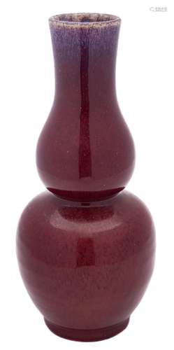 A Chinese flambé double gourd vase: the bulbous body covered in a thick red and purple streaked