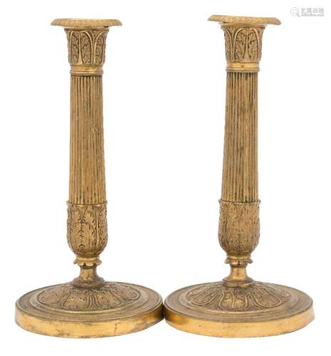 A pair of late 19th century gilt brass French candlesticks: with acanthus decorated capitals on