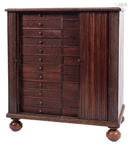 A Continental hardwood collectors tambour fronted cabinet:, the top with a moulded edge,