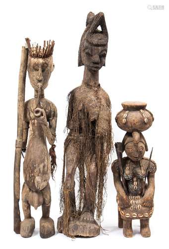 A Dogon tribe (Mali) carved wooden standing figure wearing a crown: and holding a staff in his