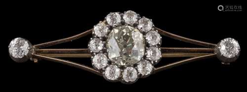 A late 19th century gold and diamond bar brooch: the central cushion-shaped old,