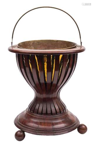 A mahogany and inlaid brazier type jardiniere:, bordered with boxwood lines,