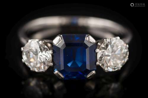 A sapphire and diamond three-stone ring: the rectangular-cut sapphire approximately 7.1mm long x 6.