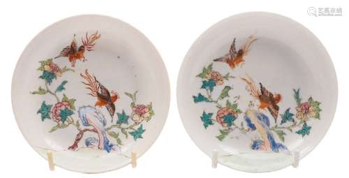 A pair of Chinese famille rose saucers: each finely painted with two phoenix,