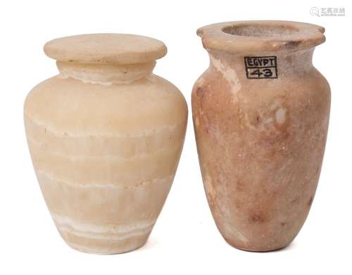 An Egyptian limestone jar: of tapering form on a flat base(rim damaged);