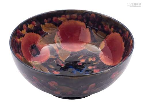 A large Moorcroft pottery footed bowl: tube lined and painted in the Pomegranate pattern,