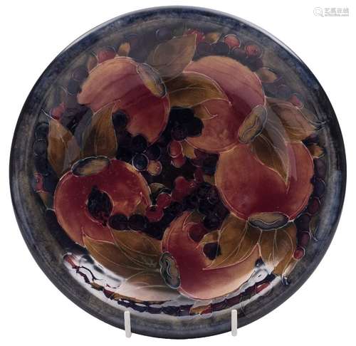 A Moorcroft pottery dish: with rolled rim, tube lined and painted in the Pomegranate pattern,