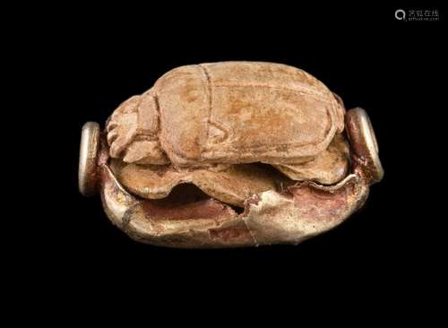 An ancient Egyptian gold mounted scarab seal bead approximately 17mm long,