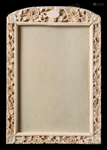 A Canton ivory rectangular frame: carved with a vacant cartouche and a continuous band of flowers