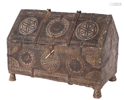 A 17th Century carved oak and metal bound coffret: of angled arch rectangular shape,