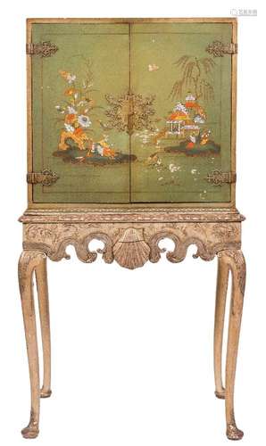 A green lacquer and chinoiserie brass mounted cabinet on carved and silvered wood stand:,