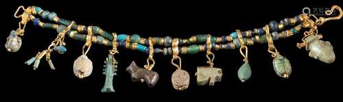 An antique gold, bead and charm bracelet: with two strings of glass,