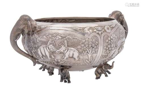 A large Burmese white metal bowl: of circular outline, with embossed panels depicting village life,