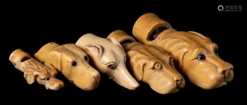 A group of five 19th century carved ivory dog's head whistles: naturalistically carved,