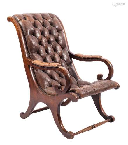 A stained beech and brown buttoned leather armchair:, with curved back,