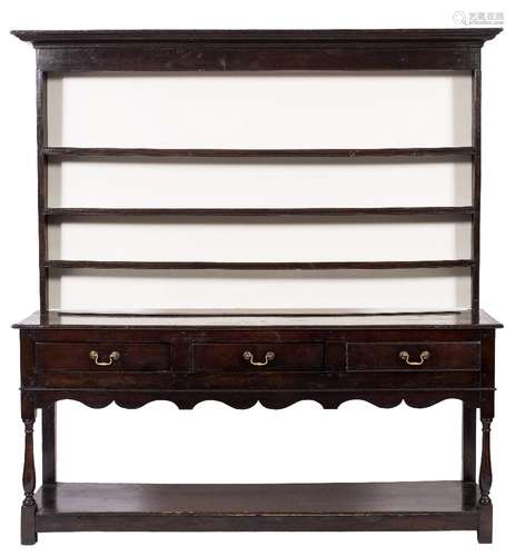 An oak dresser:, the shelved superstructure with a moulded cornice,