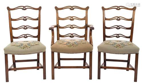 A set of eight 19th Century carved mahogany ladderback dining chairs:, in the George III taste,