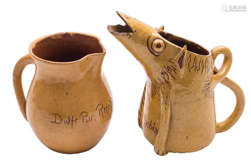 A Ewenny slipware pottery pig jug and a similar baluster jug: both in yellow over brown,