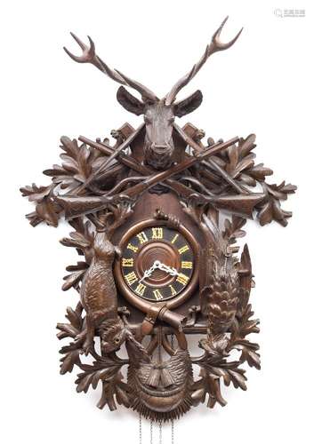 A large carved Black Forest cuckoo wall clock: the eight-day duration weight-driven movement