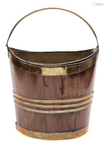 An 18th century mahogany and brass bound navette shaped bucket: of coopered construction,