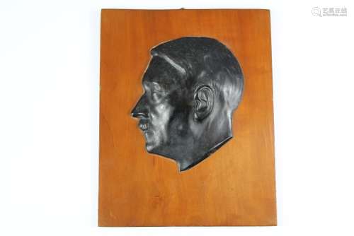 A WWII Era Bakelite Bust of Adolph Hitler in relief on a fruit-wood support, approx 21 h x 17 w cms