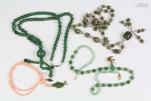 Green Hard Stone Necklaces: a Chinese style green hard stone necklace, approx 63 cms, a green bead necklace with 9ct stamp swallow, approx 50 cms, green Chinese-style bead and disc necklace, approx 70 cms and a pink bead and green hard stone necklace with fish carved drop, approx 48 cms