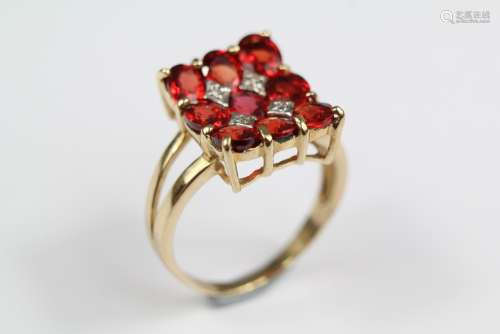 A 9ct Gold Diamond and Garnet Ring, the ring set with nine oval garnets approx 5 x 4 mm, size O+, approx 4