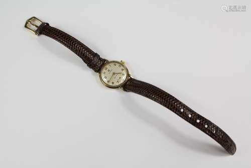 A Lady's Vintage Cyma Wrist Watch, having a champagne face with numeric dial, on brown leather strap
