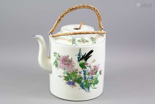 A Large Oriental Ceramic Tea Pot, hand painted with chrysanthemum and birds in flight, bamboo handle