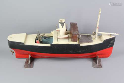 A Vintage 'Steam' Pond Tug Boat; the tug boat rests on a stand, approx 68 x 17 x 23 cms, a wonderful restoration project (af)