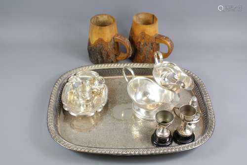 A Box of Silver Plate Items: This lot includes a tray with pierced edge, two sauce boats, salt and pepper, six napkin rings, two small trays etc