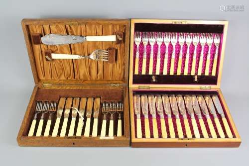 A Box of Fish Knives and Forks; the bone-handled cutlery has decorative blades, in the original wooden case with brass medallion to top together with a set of six fish knives and forks and fish servers in the original wooden case