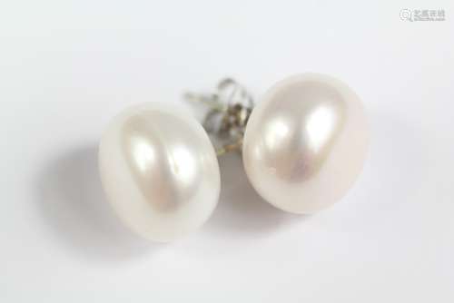 A Pair of Cultured Button Pearl Stud Earrings; the pearls measure approx 12 mm, on silver posts