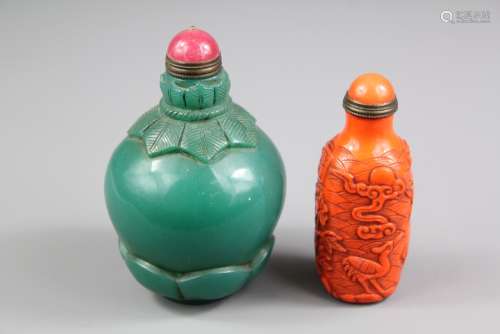 Two Chinese Scent Bottles, including a bright orange bottle carved with cranes and green scent bottle with decorative carving to the base both with stoppers