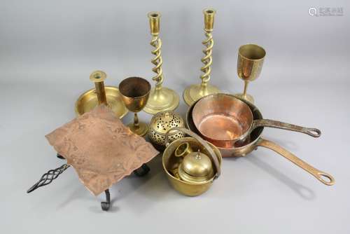 A Box of Brass and Copper Items: This lot includes two copper pans, trivet, brass candlesticks, goblets, small trays, a coal scuttle etc