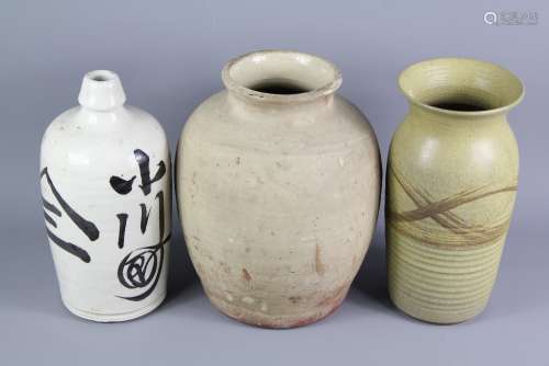 Three Studio Pottery Pots, including a Japanese Cream-Glazed Flagon, approx 27 cms h, an oat-meal glazed approx 26 cms h and a large un-glazed pot approx 27 cms h
