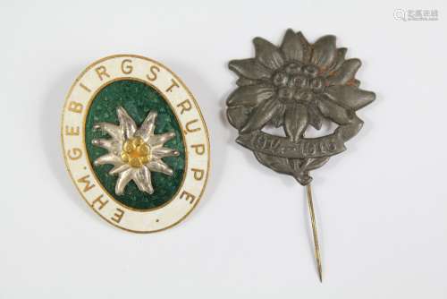 A German Silver Mountain Troops War Era Edelweiss Lapel Badge, together with a green enamel Edelweiss badge