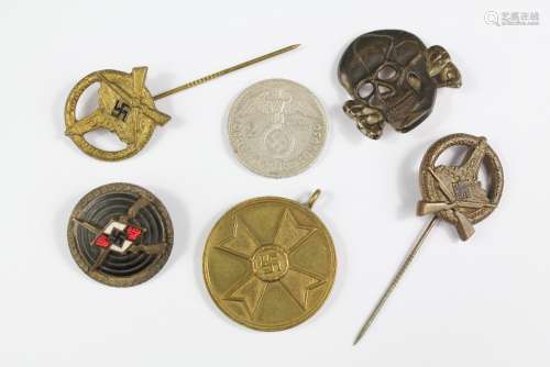 WWII Era German SS and Nazi Insignia, including a rare SS troops cap/collar badge, two brass marks men stock pins, enamel collar marksmen pin stamped RZM, brass Nazi medallion 1939, 2 Deutsche Reichsmark coin