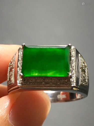 A ICY GREEN JADEITE CARVED SADDLE RING , TYPE A