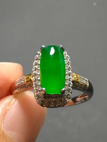 A ICY GREEN JADEITE CARVED SADDLE RING , TYPE A