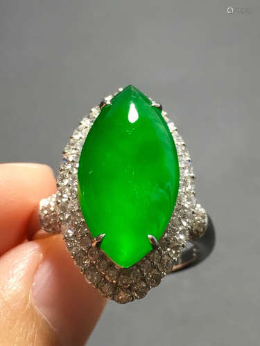 A ICY GREEN JADEITE CARVED EYE RING , TYPE A