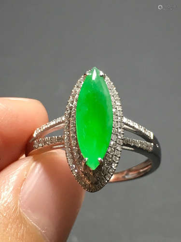 A ICY GREEN JADEITE CARVED EYE RING , TYPE A