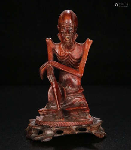 A FIGURE OF SKINNY ARHART RED WOOD ORNAMENT