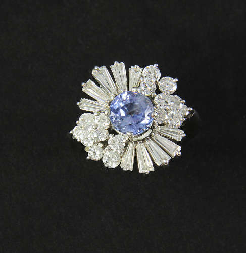 Ladies' 18k white gold diamond and sapphire ring, having one round faceted cornflower blue sapphire,