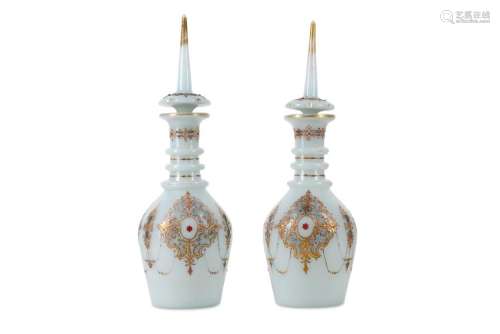 A PAIR OF OPALINE GLASS DECANTERS FOR THE OTTOMAN