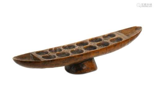 A WEST AFRICAN BOAT SHAPED GAME BOARD