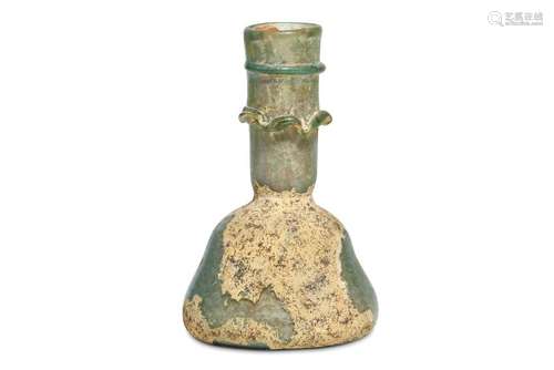 A ROMAN GREEN GLASS UNGUENTARIUM