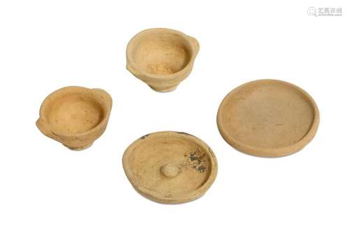 A GROUP OF FOUR MINIATURE TERRACOTTA VOTIVE VESSELS